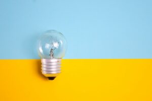 a light bulb on a blue and yellow background